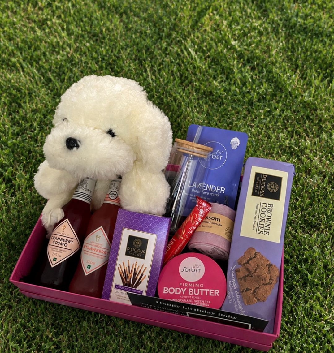 Lavender gift box with a cream teddy, pamper products and treats — presentation example